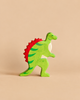 A handcrafted Holztiger Spinosaurus Dinosaur, green with a red spined back.