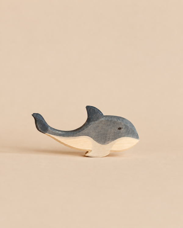 Hand-carved Ostheimer Whale toy with a blue-grey top and a natural wood underside.