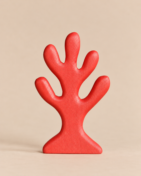A stylized Handmade Holzwald Red Coral wooden sculpture in the shape of a red coral branch.