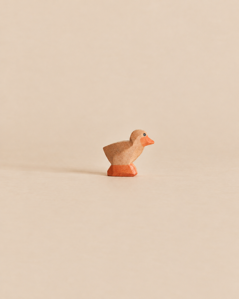 Handcrafted Ostheimer Chick, Brown figurine with an orange beak and feet.