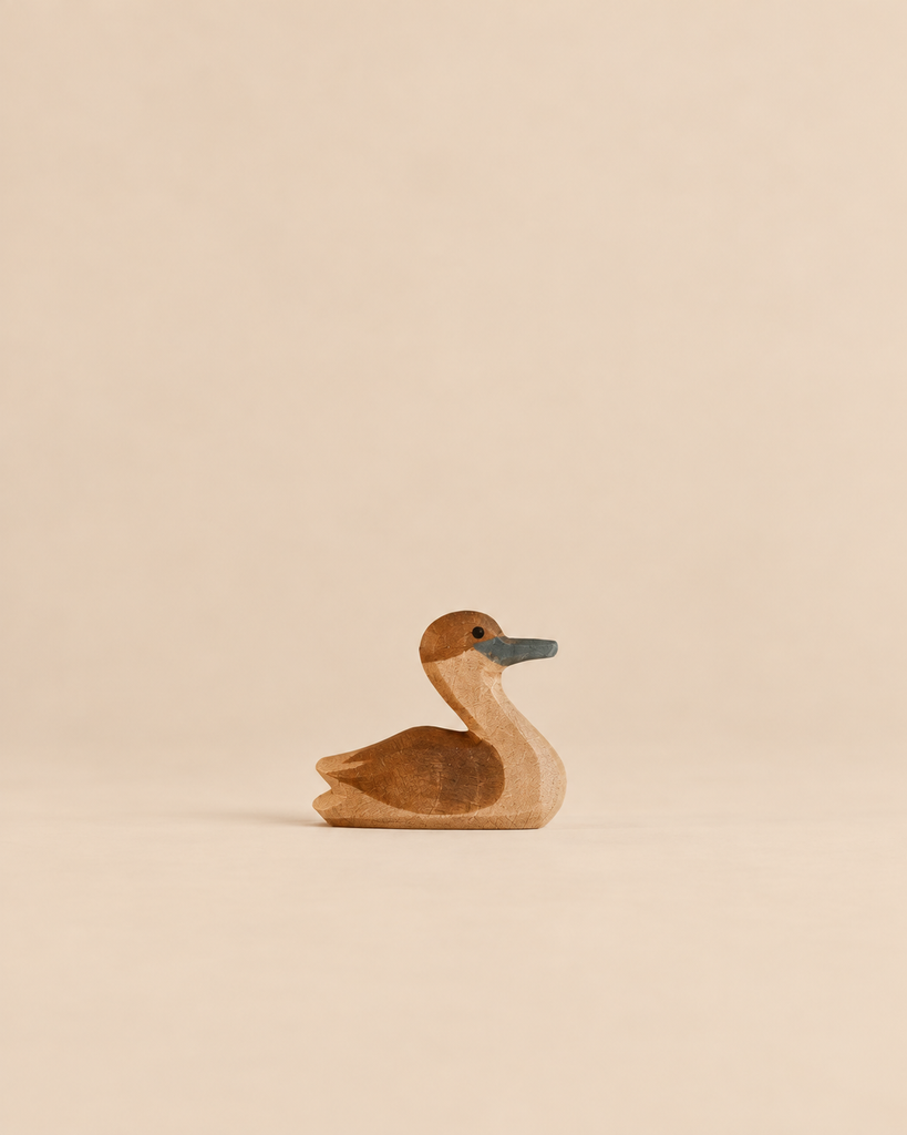 Ostheimer Canada Goose - Small, a handcrafted wooden figurine with brown details and a dark bill.