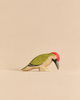 Handmade Holzwald Bird - Woodpecker figurine for imaginative play, featuring a green back, red crest, and dark grey beak.