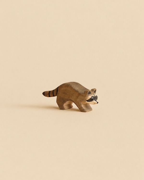 Handcrafted Ostheimer Raccoon Running wooden toy figurine in a running pose.