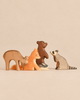 An Ostheimer Handmade Wooden Woodland Animals Set featuring handcrafted figures of a deer, fox, bear, small rabbit, and raccoon.