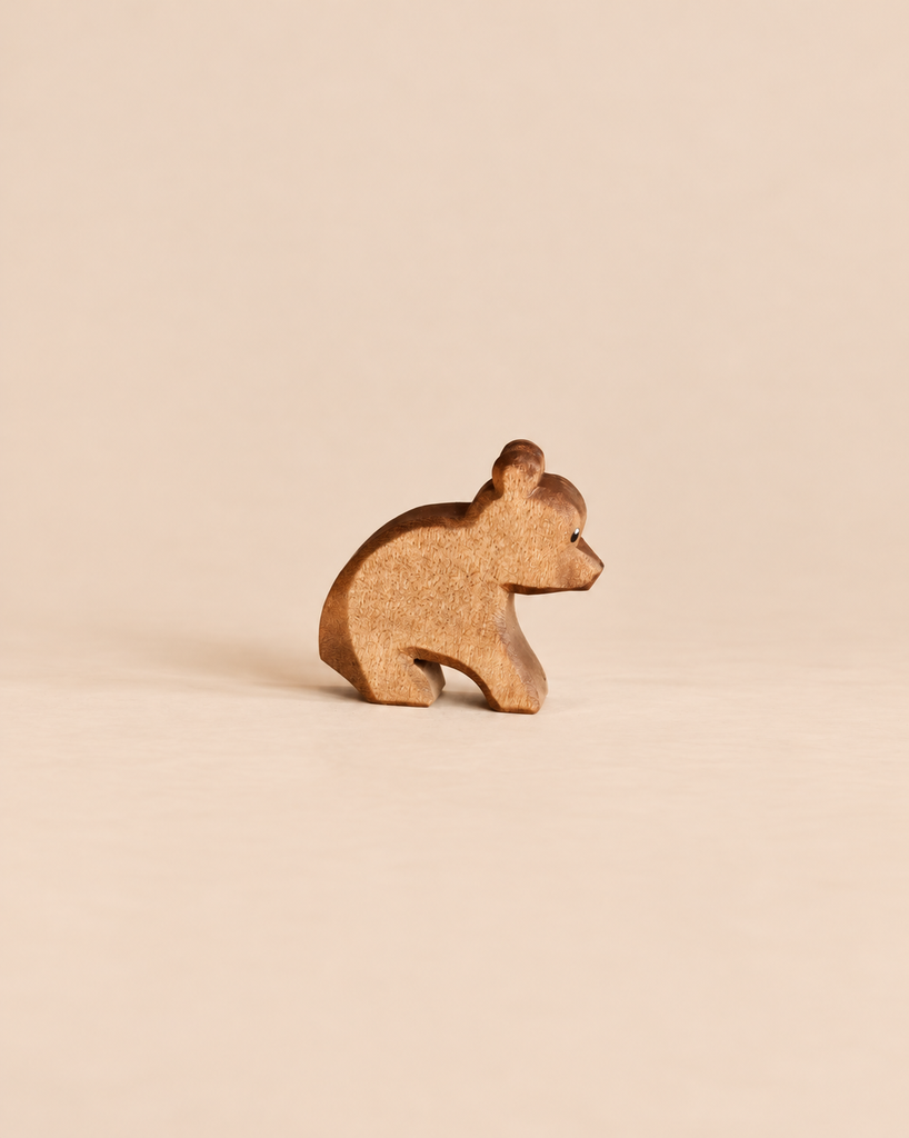 Ostheimer Small Bear - Sitting, a handcrafted wooden toy bear in a sitting position, perfect for imaginative play.