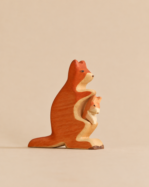 A Handmade Holzwald Kangaroo With Baby, featuring a carved wooden kangaroo with a baby joey in its pouch.