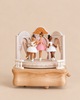A Ballerina Music Box featuring three dancing ballerina figurines on a wooden stage set with decorative arches.