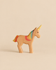 Handmade Holzwald Fairy Tale Set wooden unicorn toy with a painted rainbow mane and tail and a yellow horn.