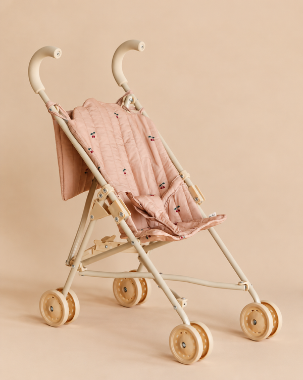Konges Sloejd Doll Stroller - Cherry Blush with a blush pink fabric, cherry print, double wheels, and a cream-colored frame.