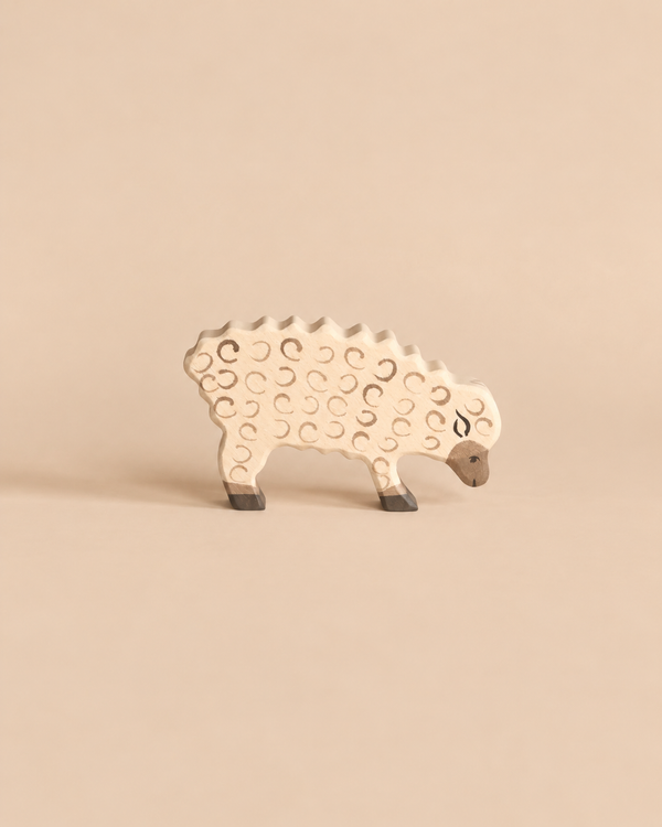 Holztiger Sheep, Eating, a handcrafted wooden toy with a carved wool texture and lowered head.