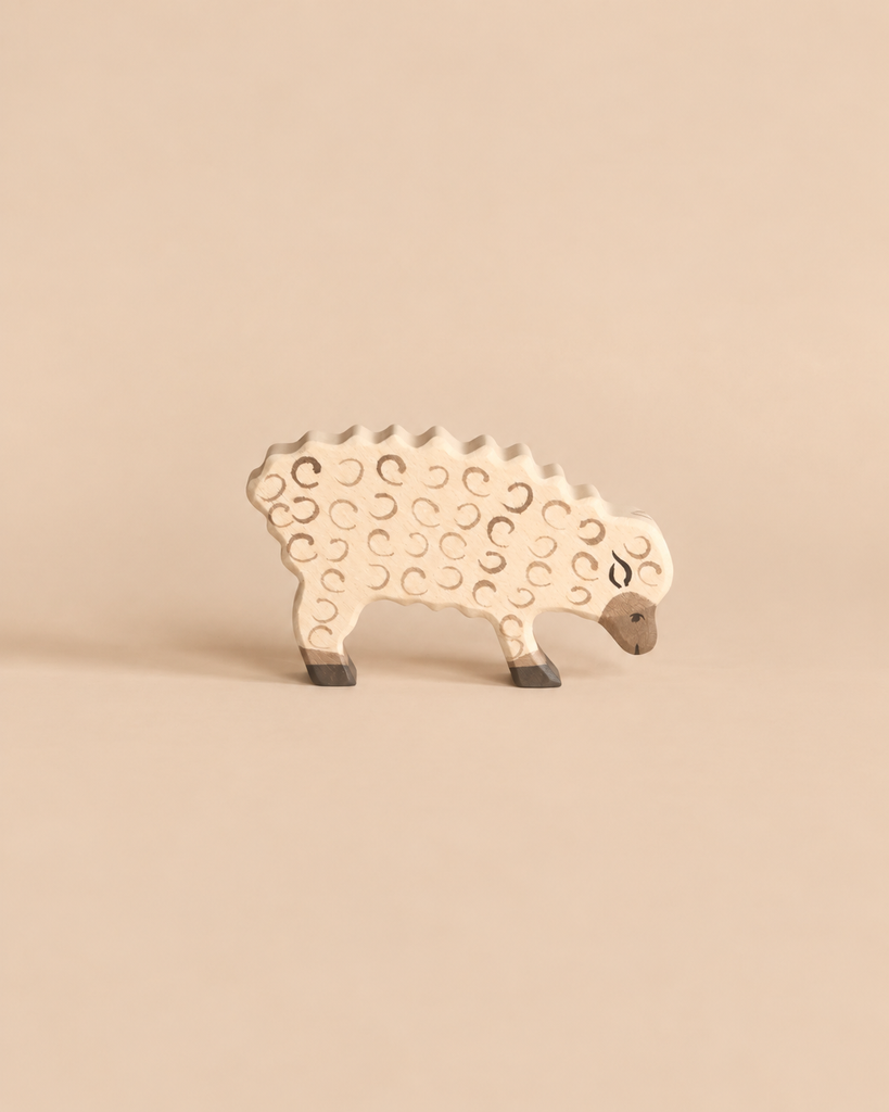 Holztiger Sheep, Eating, a handcrafted wooden toy with a carved wool texture and lowered head.