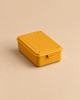 Mustard-colored Toyo - Steel Stackable Storage Box T-150 toolbox with a flat lid and a small latch, ideal for organizing art supplies.