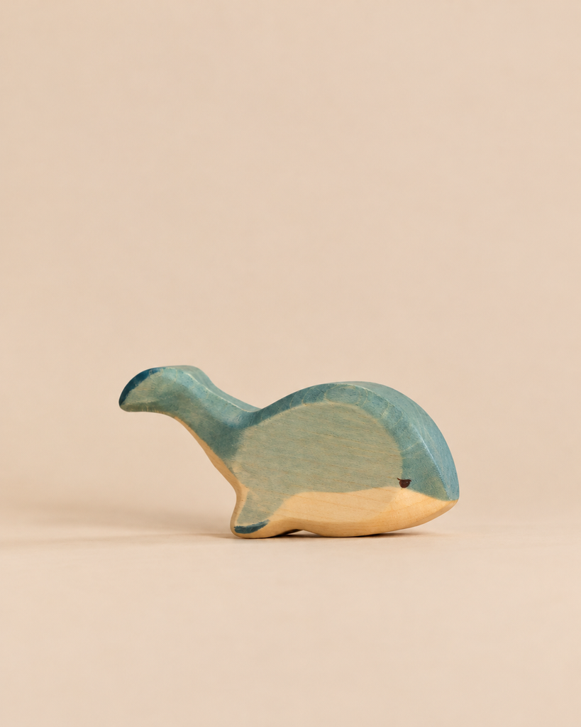 Handmade Holzwald Whale figurine, stylized and crafted from wood in shades of blue and natural wood.