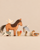 An Ostheimer Handmade Wooden Farm Animals Set including a handcrafted wooden horse, pig, donkey, duck, chicken, and bird.