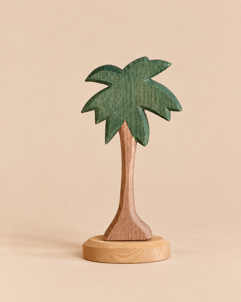 Ostheimer Tree - Palm with Stand, Leaves Up, a handcrafted wooden palm tree toy featuring a green leafy top and a brown trunk on a round base.