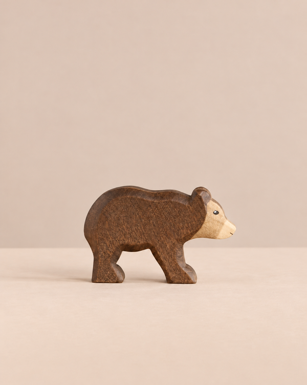 Handmade Holzwald Small Bear - Walking, a small wooden toy bear in a walking pose with a dark brown body and a light tan face, crafted as a sustainable toy.