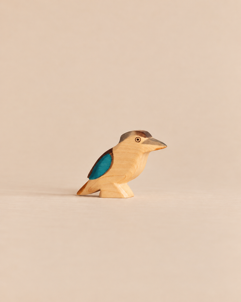 Handmade Holzwald Bird - Kookaburra wooden figurine for imaginative play, featuring a brown head, blue wing accent, and a light-colored body.