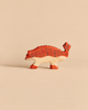 Handcrafted wooden Holztiger Ankylosaurus Dinosaur with a red back and tail, patterned with dark chevron markings.