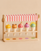 Ice Cream Scoops and Smiles wooden toy set displayed on a stand featuring five colorful cones with smiling faces.