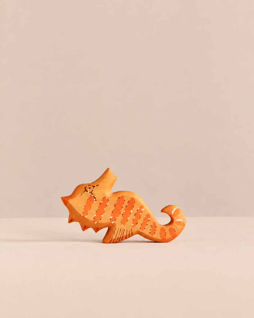 Handmade Holzwald Sea Horse, a small wooden figurine painted with orange stripes and white dots.