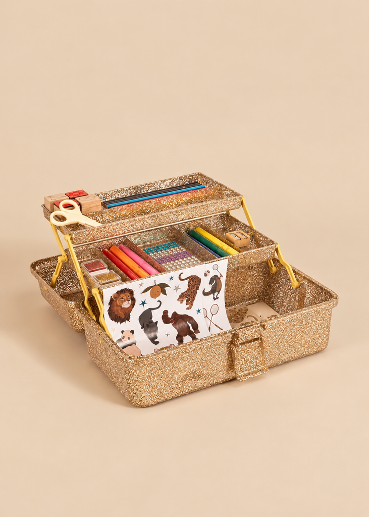 Gold glitter-covered tiered Konges Sloejd Creative Art Caddy - Tiger filled with a kids art supplies coloring set, including pens, a pair of scissors, and a sheet of animal stickers.