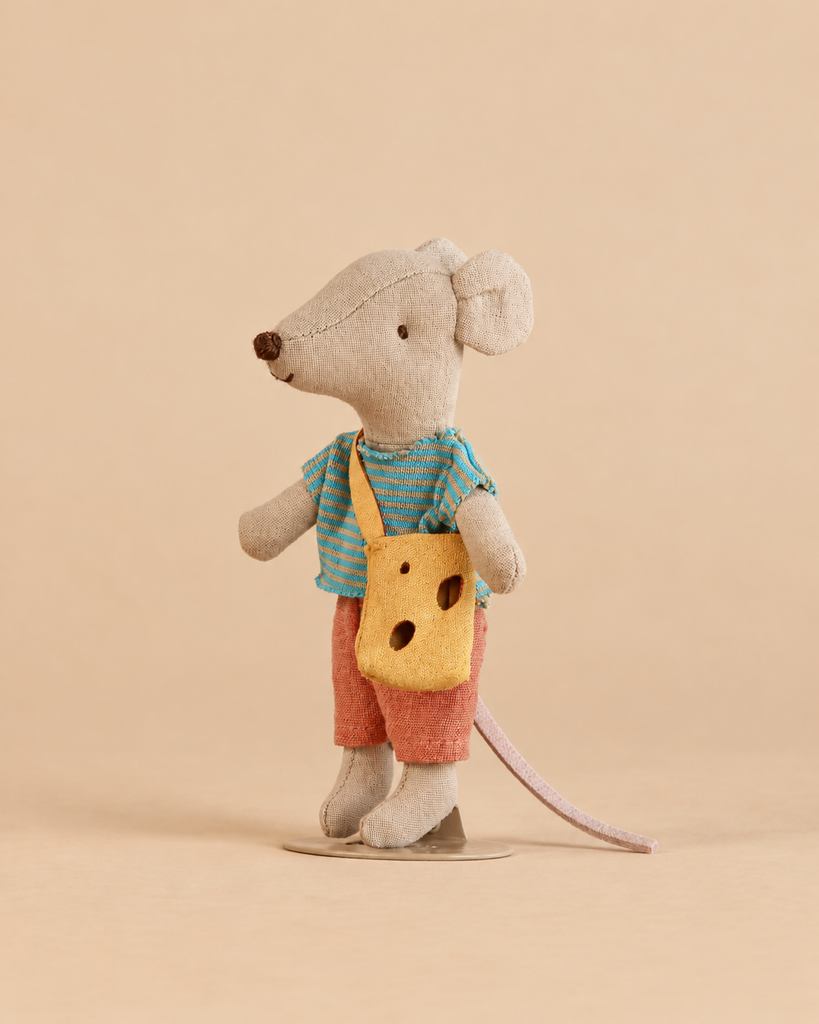Maileg Little Brother Mouse with Bag wearing a striped shirt and shorts, carrying a yellow bag with holes that resembles a piece of cheese.