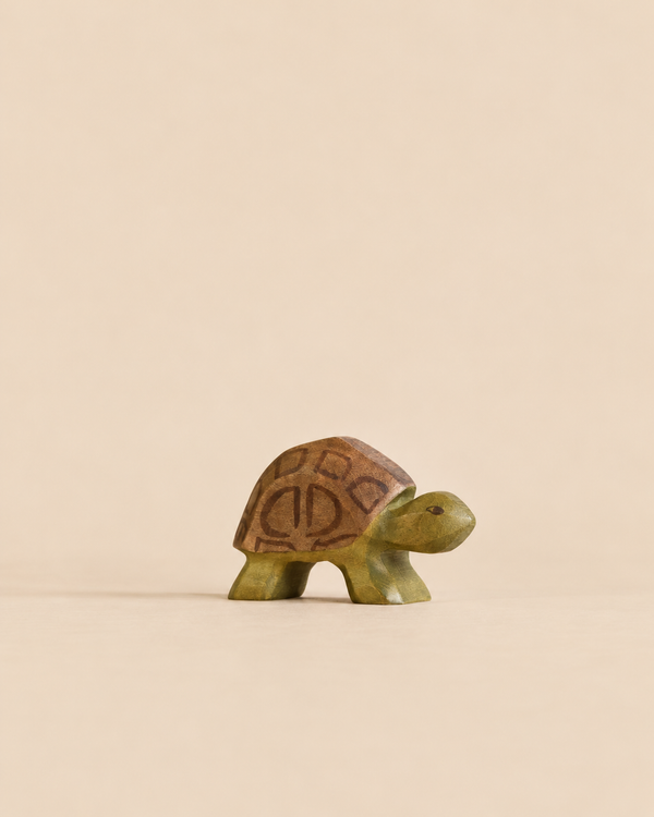 Handmade Holzwald Turtle toy with a brown shell and green wooden body.