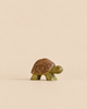Handmade Holzwald Turtle toy with a brown shell and green wooden body.
