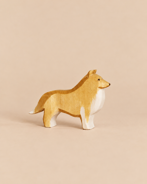Ostheimer Dog - Collie Dog, a handcrafted wooden figurine of a standing dog with a tan and white coat, made from sustainably sourced materials.