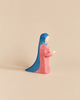 An Ostheimer Mary - Standing handcrafted wooden toy figurine of a woman in a long pink dress and a blue head covering, depicted in a standing or kneeling pose with hands held forward.