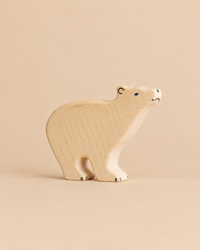 Hand-carved Holztiger Polar Bear figurine featuring simple painted eyes and claw details on a handcrafted wooden animal figure.