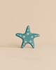 Handmade Holzwald Starfish toy in blue wood with white polka dots.
