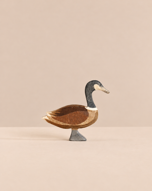 Hand-carved Ostheimer Canada Goose - Standing figurine with a black neck, brown wings, and a gray base.