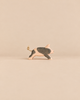 Ostheimer Spotted Piglet - Running: a handcrafted wooden toy piglet in a running pose with dark patches and a knotted string tail.