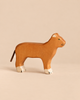 Handcrafted Holztiger Lioness wooden toy with a tan body, white-tipped paws, and a cord tail.