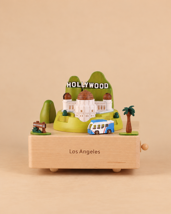 A Los Angeles Wooden Music Box featuring a miniature Griffith Observatory, the Hollywood sign, a tour bus, and a palm tree.