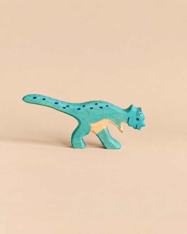 Handcrafted Holztiger Pachycephalosaurus Dinosaur painted turquoise with dark blue spots.