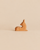 Handcrafted Ostheimer Deer - Fawn, Lying Down made in Germany, a wooden figurine featuring painted white spots.