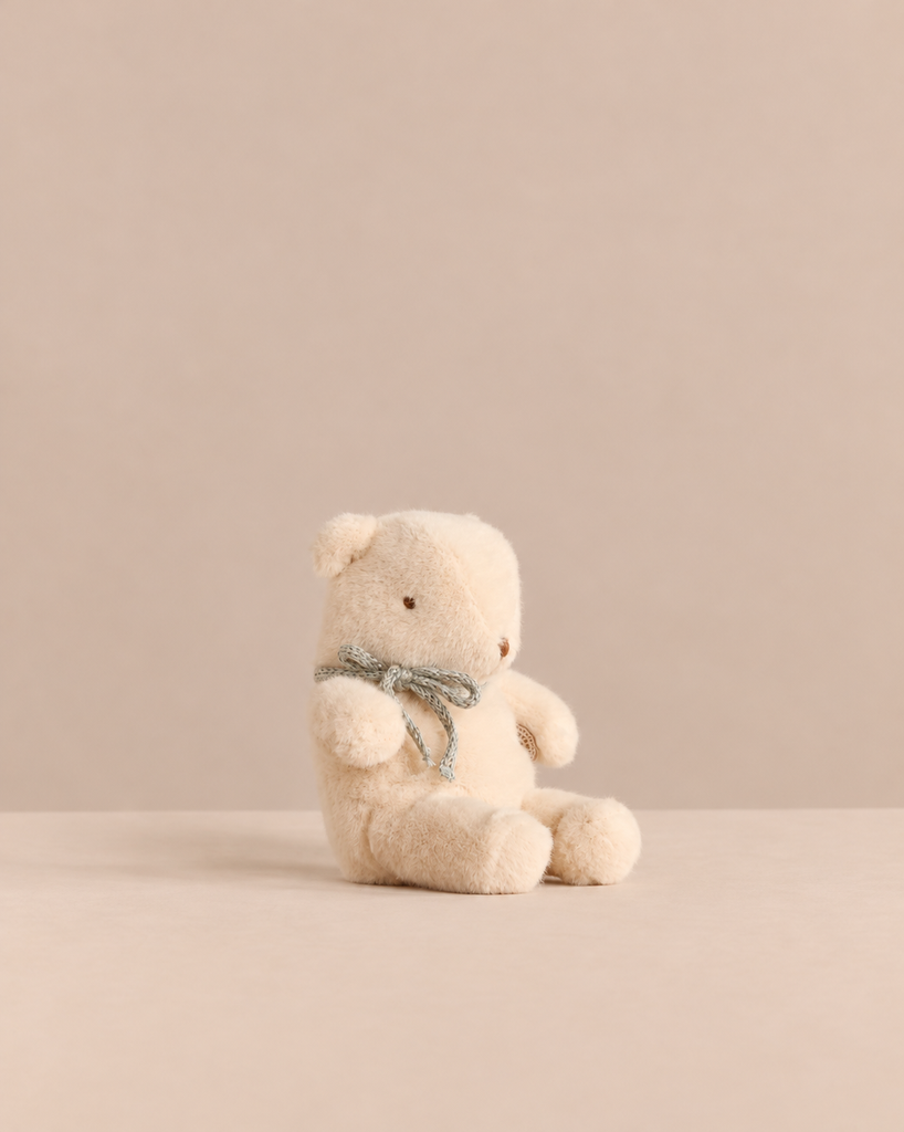 Maileg Teddy Bear Plush, Mini - Off White vintage teddy bear with a small grey ribbon around its neck.