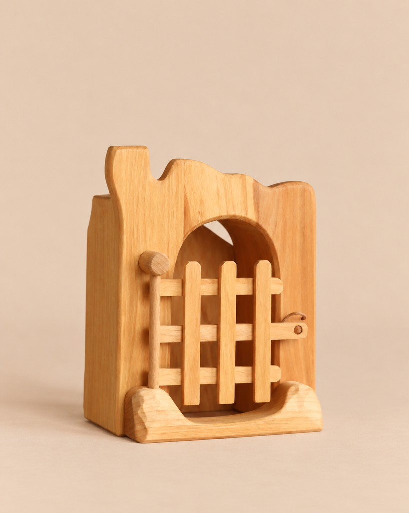 Ostheimer Jailhouse handcrafted wooden toy structure featuring an arched doorway with a movable barred gate.