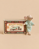 A Maileg Little Brother Mouse in Matchbox stands next to its decorative matchbox, which features a vintage-style “Mouse Race” illustration, while the mouse wears light blue polka-dot pajamas.