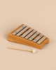 Choroi Carillon Pentatonic Glockenspiel - 7 tones featuring metal bars mounted on a curved cherry wood base, accompanied by a single mallet.