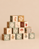 A pyramid of Uncle Goose Watercolor ABC Blocks, sustainable wooden cubes featuring painted watercolor illustrations of letters, animals, and plants.