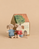 Maileg LouiMax and Stella, Little Brother and Sister Mice wearing striped shirts and blue pants sit in front of a small SuitCasa cardboard house.
