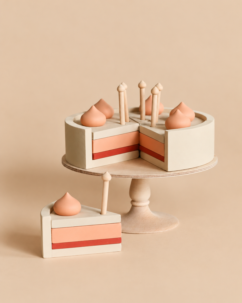 Sabo Concept Handmade Strawberry Layer Cake On A Stand on a pedestal, with one slice removed and a matching slice sitting in front.