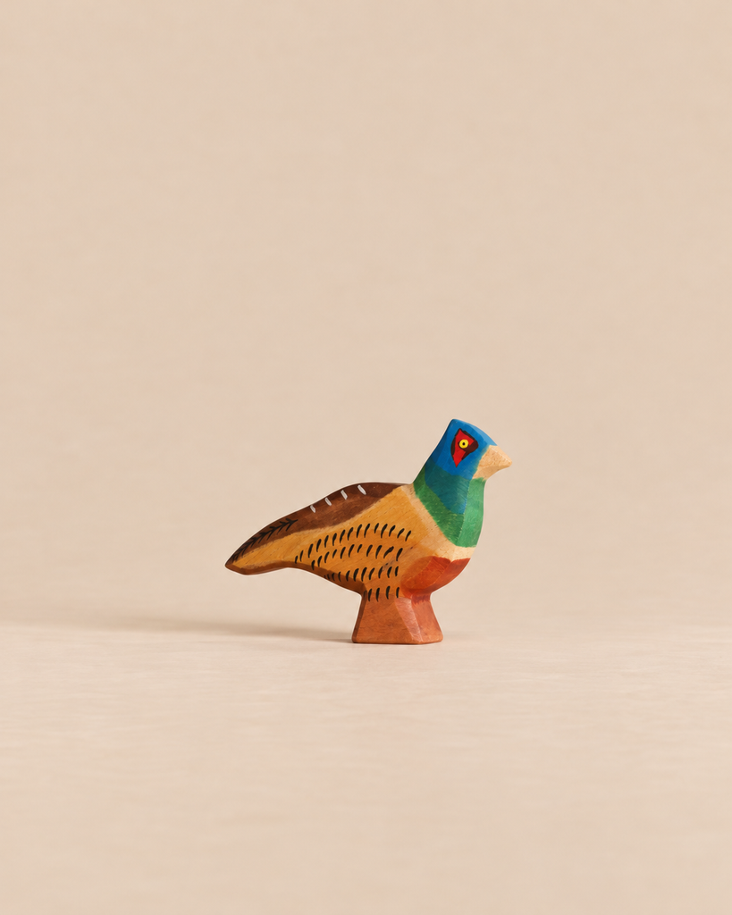 Handmade Holzwald Bird - Pheasant, a small, hand-painted wooden toy with a blue head, green neck, and brown and yellow body.