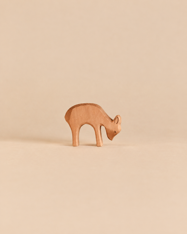 Handcrafted wooden Ostheimer Deer - Eating figurine of a deer with its head lowered as if grazing.