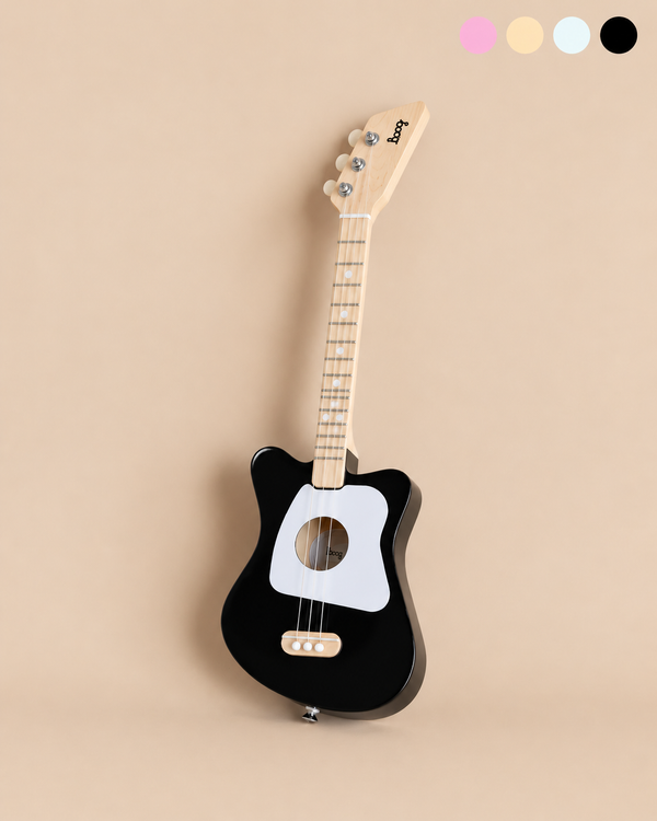 Black wooden Kids Wooden Guitar - Ages 3+ 3-string Loog Mini with a white pickguard and four tuning pegs.