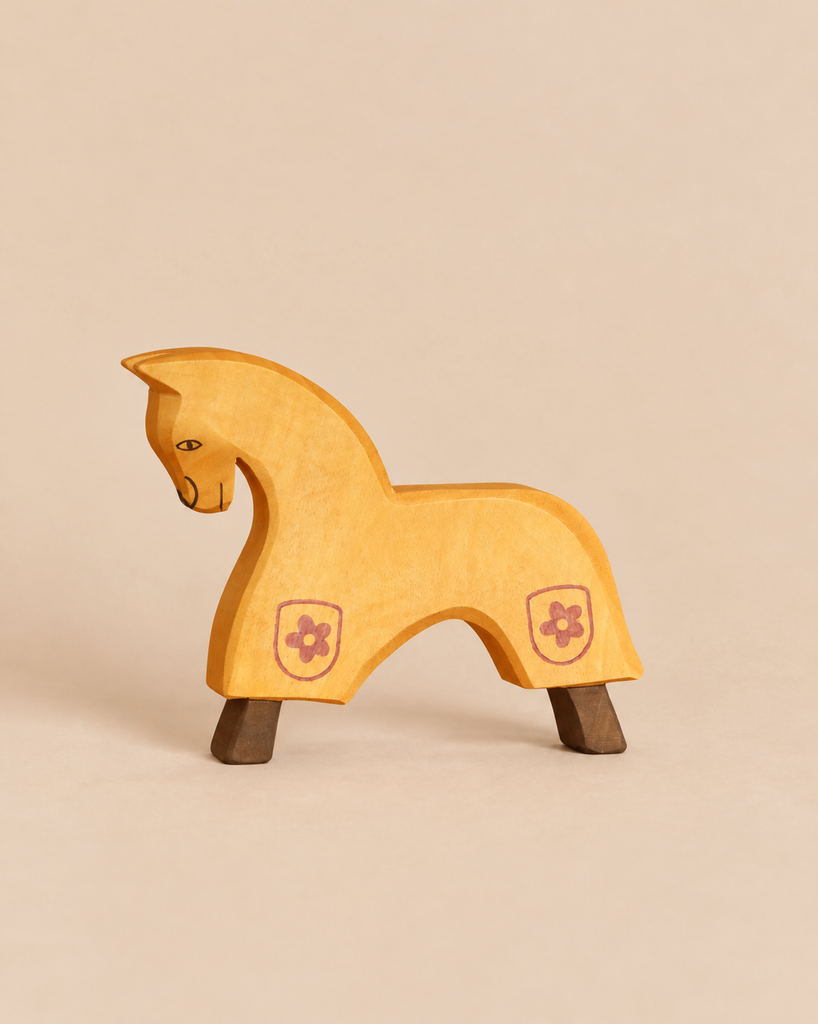 Ostheimer Yellow Horse for Knight, a handcrafted wooden toy in yellow with dark brown hooves and a small flower icon painted on its side.
