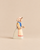 Ostheimer Farm Wife handcrafted wooden figurine of a woman wearing a blue bodice, a white apron with red trim, and a red-polka-dot headscarf.